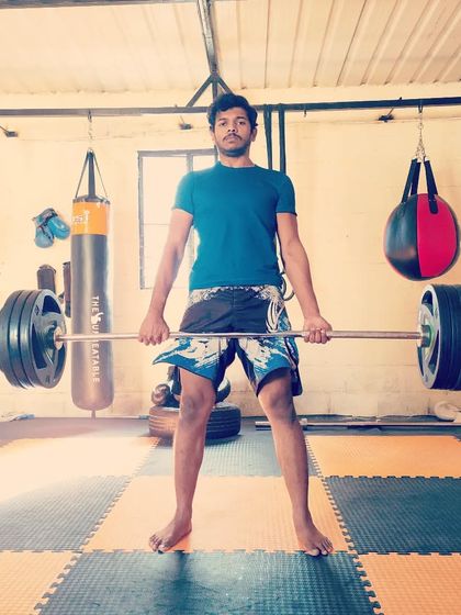 Performing a deadlift at Sai MMA. This is a core exercise in our strength program, building powerful hips and a strong back, which are crucial for grappling.