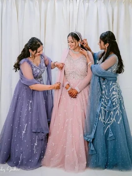 A bride getting ready with her bridesmaids. This photo captures the friendship and support that surrounds a bride on her engagement day, a beautiful moment of preparation and excitement.