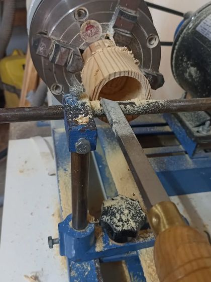 Hollowing out the inside of the box with a scraper. The 4-jaw independent chuck is holding the piece securely.