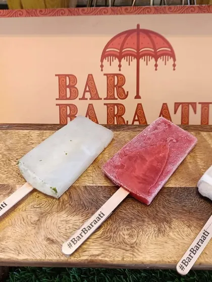 I go beyond drinks with unique treats like these alcoholic popsicles. Displayed on a rustic wooden board with custom hashtag sticks, they offer a fun and surprising way for guests to cool down and enjoy the party.