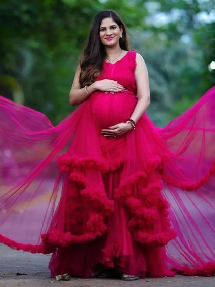 This pink cloud gown is designed to make you feel weightless and beautiful. The flowing wings and ruffled layers add a touch of magic to your maternity photos.