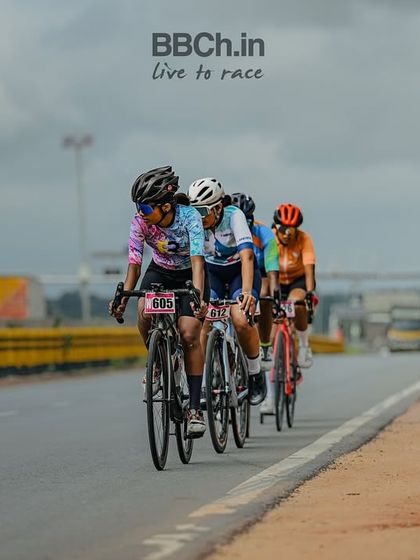 The women's peloton, a strong and competitive field, races along the highway.