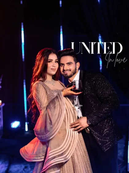 A stylish portrait of the couple, titled 'United in Love,' as they pose with a glass of wine.