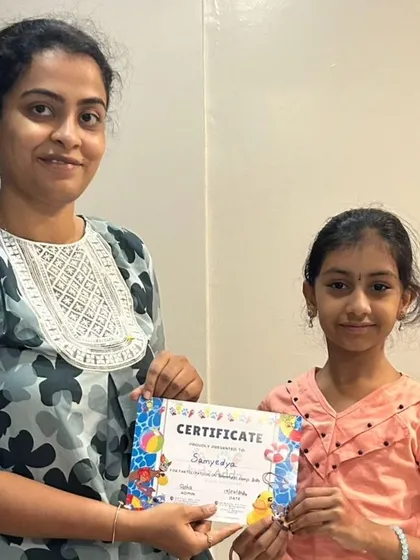 Another proud camper receives her certificate, marking the successful completion of the first batch of our summer camp.