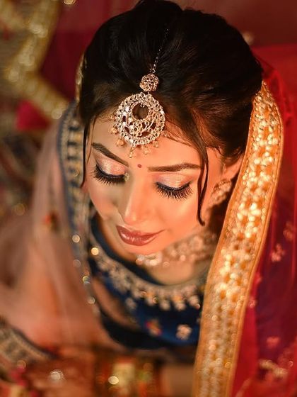 A stunning top-down portrait that captures the bride's serene expression and the details of her maang tikka.