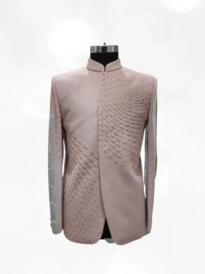 This dusty pink Jodhpuri suit showcases modern texture and design. The unique patterned embroidery and sleek fit make it a standout choice for any formal occasion.
