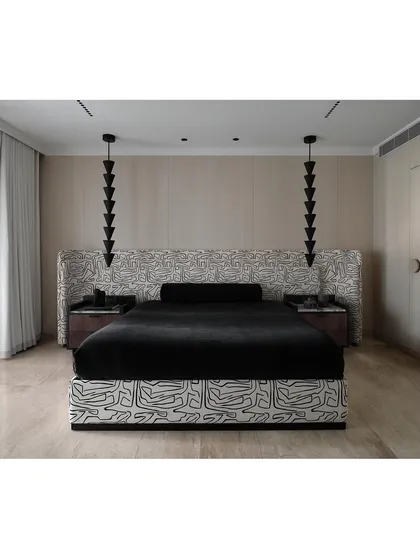 The master bedroom at The Grove Residence is a statement in monochromatic design. The graphic fabric and sculptural pendant lights create a strong visual impact in this modern luxury bedroom.