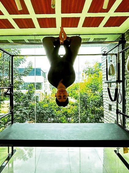 Our meditating Spidergirl. This playful yet challenging inverted pose on the Cadillac builds incredible upper body and core strength.