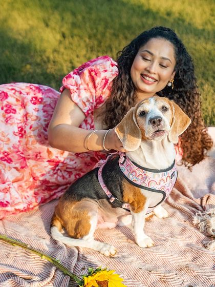 A beautiful portrait of Rrari the Beagle and her mom enjoying a quiet moment during their outdoor picnic session.