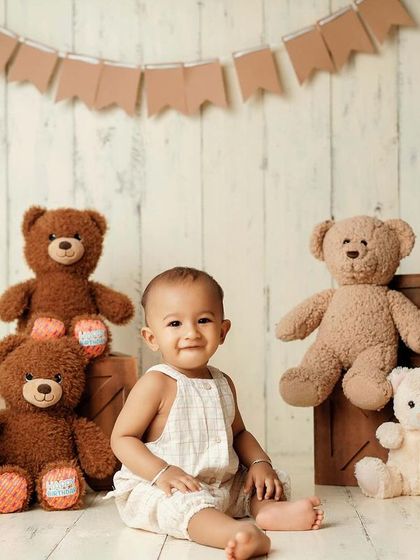 A sweet smile surrounded by furry friends. This simple and heartwarming setup is all about childhood innocence and comfort.