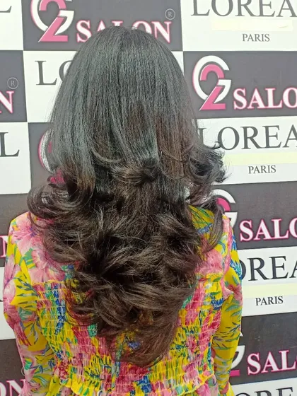 A beautiful V-shaped layered cut, styled with soft curls at the ends. This cut creates a lovely shape and adds plenty of volume.