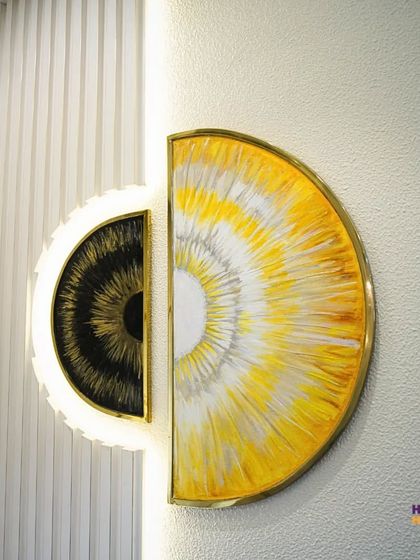 This custom wall art, made of two semi-circles, acts as a stunning focal point. The backlighting enhances its texture and makes it a conversation starter.