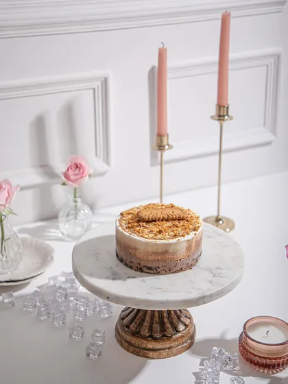 An ice cream cake topped with a crunchy biscuit crumble, showcasing the textures we love to create. A testament to three decades of our iconic dessert.