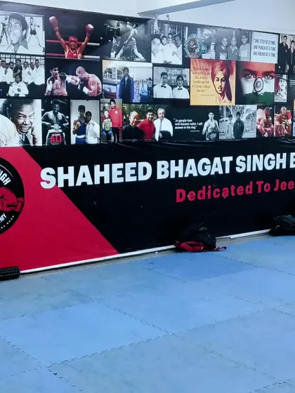 Our wall of inspiration, featuring boxing legends and a banner dedicated to our mission at Shaheed Bhagat Singh Boxing Academy.