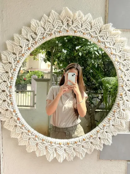 This is our largest macrame mirror to date, a 30-inch showstopper made for a client's living room. The intricate knotting and detailed leaf pattern create a stunning focal point, perfect for adding a touch of handmade elegance to any wall.