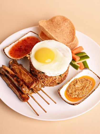 This Malay classic is a meal in itself. It features fragrant seasoned rice, tender chicken skewers, prawn crackers, and two of my secret sauces that I know you’ll love.