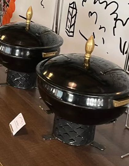 The sleek, black serving dishes used for the corporate event buffet. The modern design fits perfectly with a professional setting.