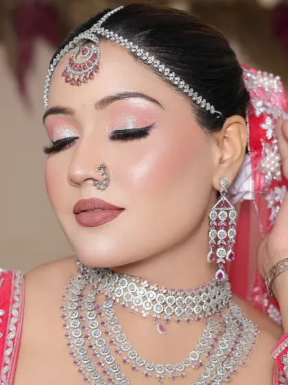 A beautiful reception look with a pink and silver theme, created by another talented student. The focus is on glowing skin and sparkling eyes.
