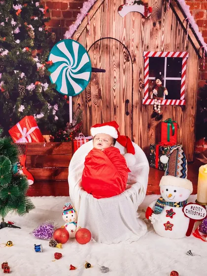 Our little Santa's helper is fast asleep. This festive Christmas-themed newborn shoot is a wonderful way to celebrate your baby's first holiday season.
