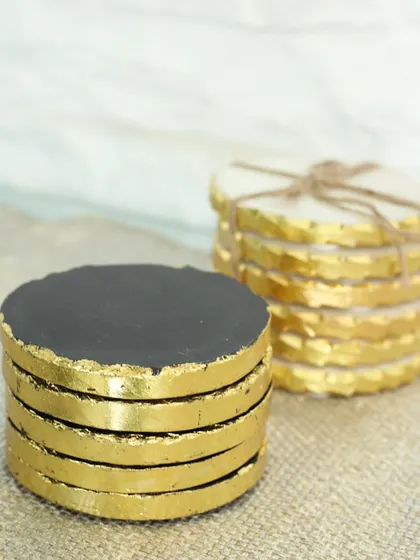 For a bolder look, we offer these black and white marble coasters with a textured gold-leafed edge. They are perfect for adding a dramatic and luxurious touch to your bar or coffee table.