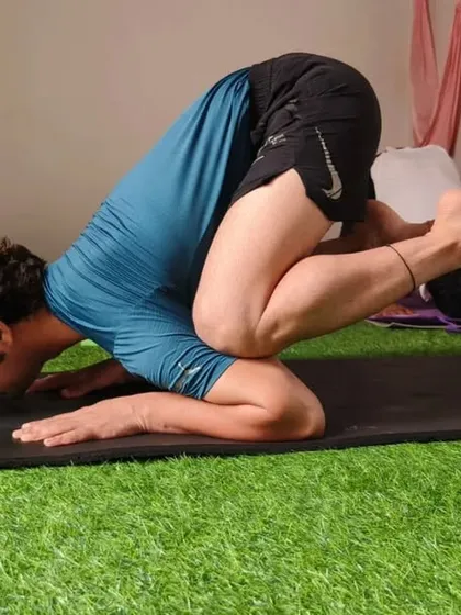 This is Baby Crow pose, a variation of crow pose done on the forearms. It's a great way to build strength for the full pose.