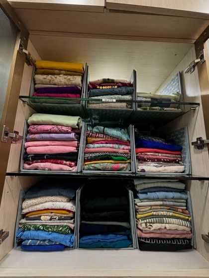 Another example of using shelf dividers to create tidy, accessible stacks of folded clothes, perfect for kurtas, dupattas, or casual Indian suits.