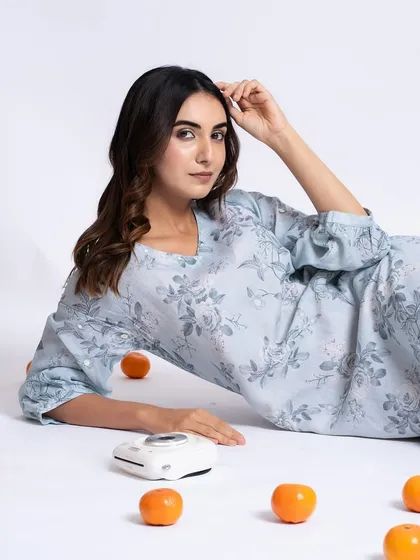 A relaxed, lying-down pose that still shows off the clean, natural makeup. This is perfect for a lifestyle or fashion catalog.