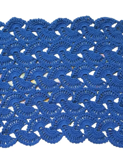 The lacy stole in a rich royal blue. The intricate crochet work is clearly visible in this shot.
