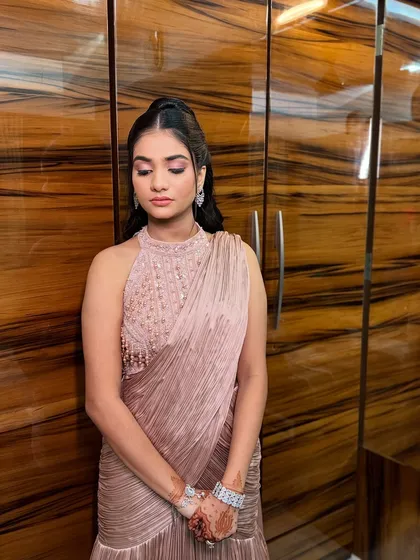 The serene beauty of a Roka bride. This look features a striking pink eyeshadow and a sleek, modern hairstyle, perfect for an intimate yet glamorous ceremony.
