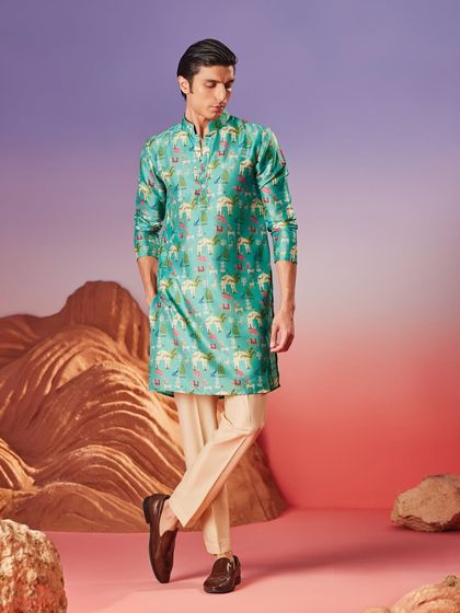 A vibrant turquoise kurta with a playful scenic print. This piece is for the man who wants to make a statement with artful and contemporary design.