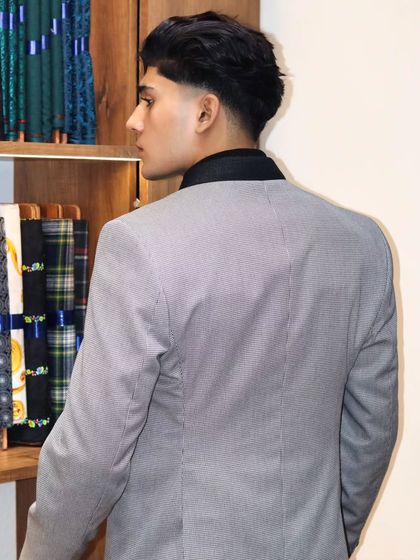 The back view of this pinstripe double breasted jacket shows the importance of a clean fit across the shoulders and back. No pulling or bunching, just a smooth, tailored line.