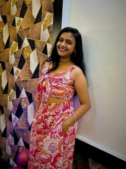 The birthday girl posing next to our geometric-patterned wall. My space is designed with many photo-friendly corners.