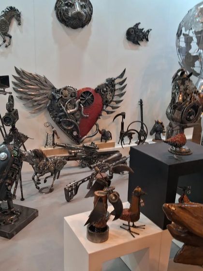 The Momas Art Gallery booth at World Art Dubai, filled with an array of imaginative metal sculptures.