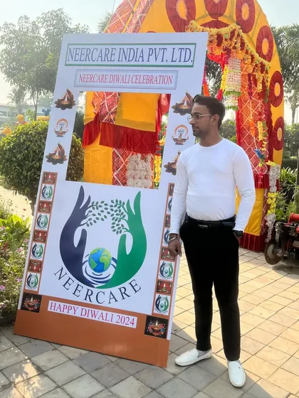 Posing by the event frame at the Neercare corporate party.