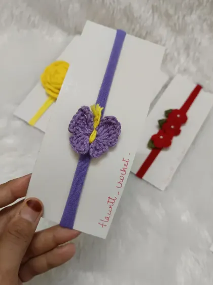 This one has a delicate purple butterfly charm on a purple band. These handmade accessories are perfect for newborn fashion.