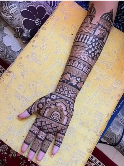 A single arm design showing the intricate details of a traditional pattern, with peacocks, elephants, and lotus flowers.
