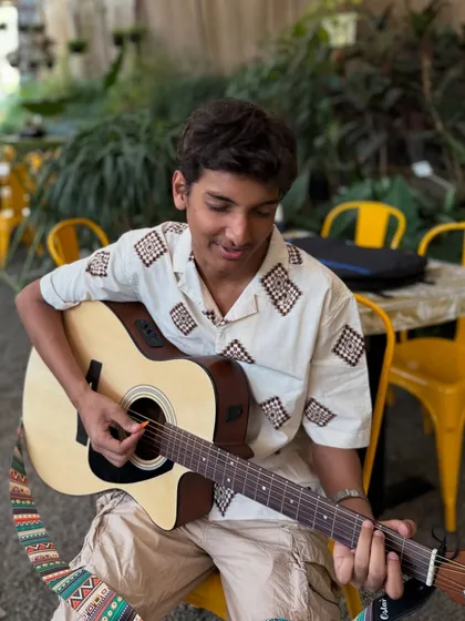 A young artist lost in his music during a practice session at our cafe. We welcome musicians to come and use our inspiring space to jam and create.