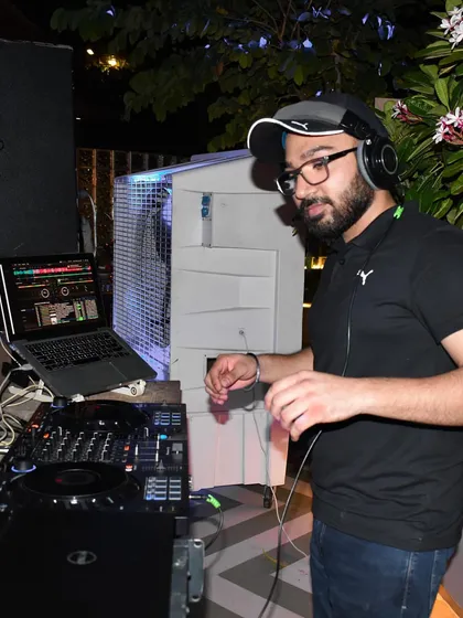 In the zone at an outdoor private party. As an audio engineer, I'm obsessed with sound quality, ensuring every beat is crisp and clear, whether it's a booming wedding hall or a relaxed cocktail evening.