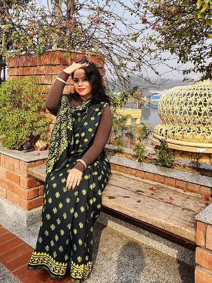 A candid moment in a festive saree, showing how you can be comfortable and stylish while celebrating.