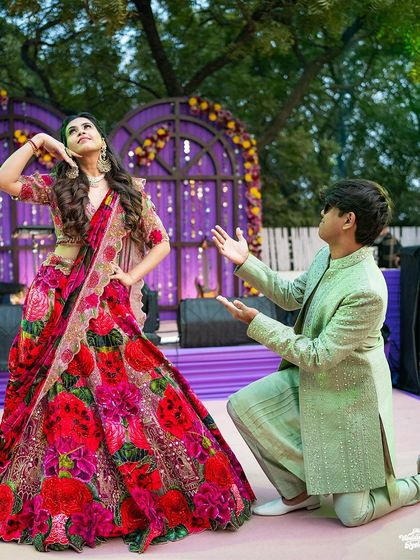 A playful and choreographed dance move by the couple, showcasing their fun-loving personalities.