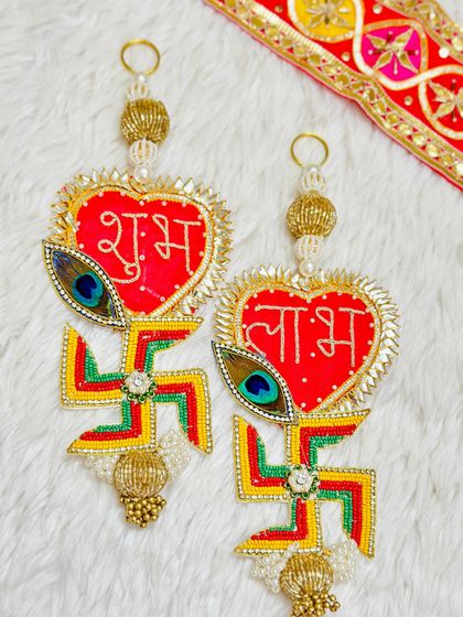 This unique Shubh Labh set features a colorful swastika design with a peacock feather accent. The heart shape adds a modern twist to the traditional symbol.