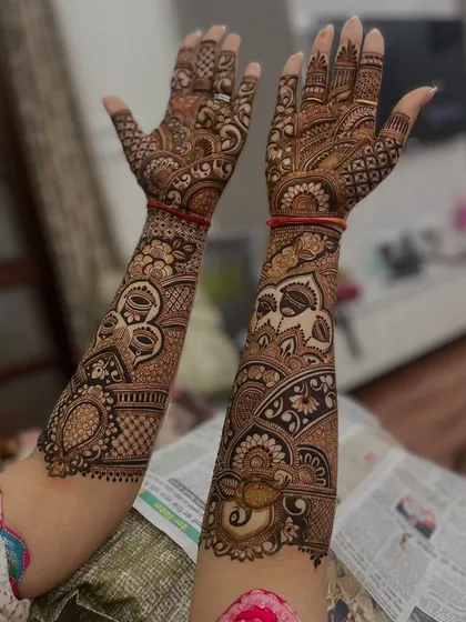 Another angle of the same intricate design, showing the beautiful flow of patterns from the hands to the arms.