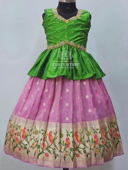 A beautiful parrot green and pink lehenga. The skirt features a Paithani-style border with colorful bird motifs.