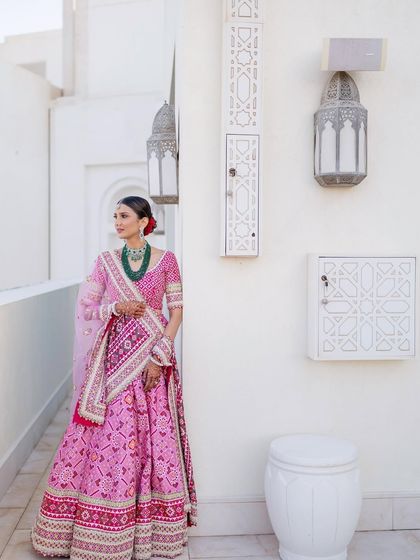 A full view of this graceful and culturally rich look. The makeup was kept refined and minimal to complement the vibrant colors and patterns of her traditional attire.