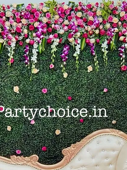 A close-up of the floral photo wall, showing the cascading orchids and roses that create a luxurious and vibrant texture.
