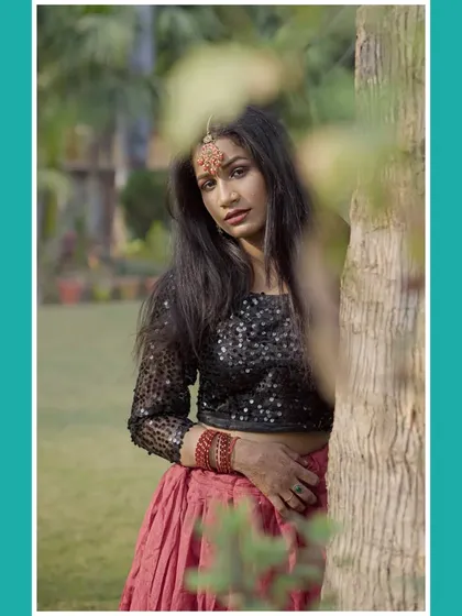 Another creative shot using leaves to frame the model, adding an artistic touch to the fashion portrait.