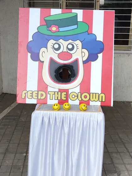 'Feed the Clown' is a fun and simple ball toss game, perfect for younger children. The goal is to throw the smiley-face balls directly into the clown's mouth.