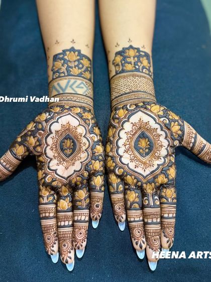 A custom Indian mehendi design with a prominent lotus motif in the center, surrounded by delicate floral work.