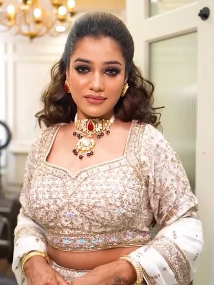 This look was for a reception or cocktail party. I created a dramatic dark smokey eye, balanced with a soft nude lip. The voluminous, wavy hair adds a touch of modern glamour.