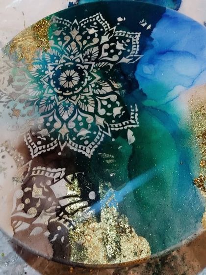 Another angle of the alcohol ink mandala art. You can see how the light catches the gold leaf and the different layers of ink, creating a dynamic and beautiful effect.